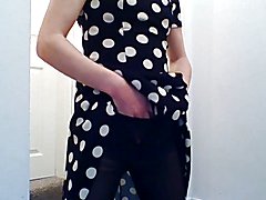 Crossdresser masturbating in a black and white spotted dress with black, lacey lingerie and ...
