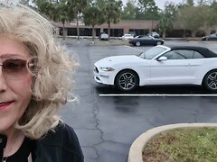 A lovely blond t-girl is seen driving a car, walking outside, shopping in a mall and wearing...