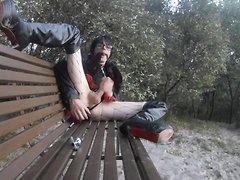 A sissy slut in leather takes her outdoor anal play to the public, gagging on her toys while...