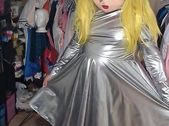 A kinky cosplay scene featuring a shemale dressed in a layered silver dress and PVC, engagin...