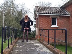 A mature crossdresser in sexy PVC attire masturbates outdoors, showing off her hot and sexy ...