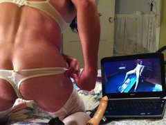 Nasty crossdresser dressed in a sexy female lingerie is watching a porn video and getting so...